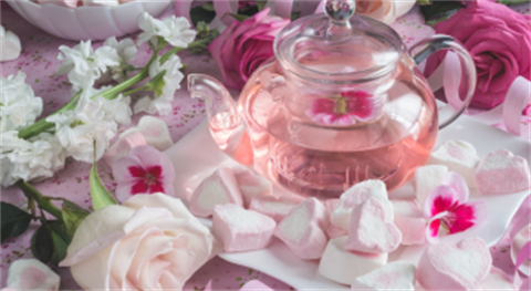 tea pot on table with roses